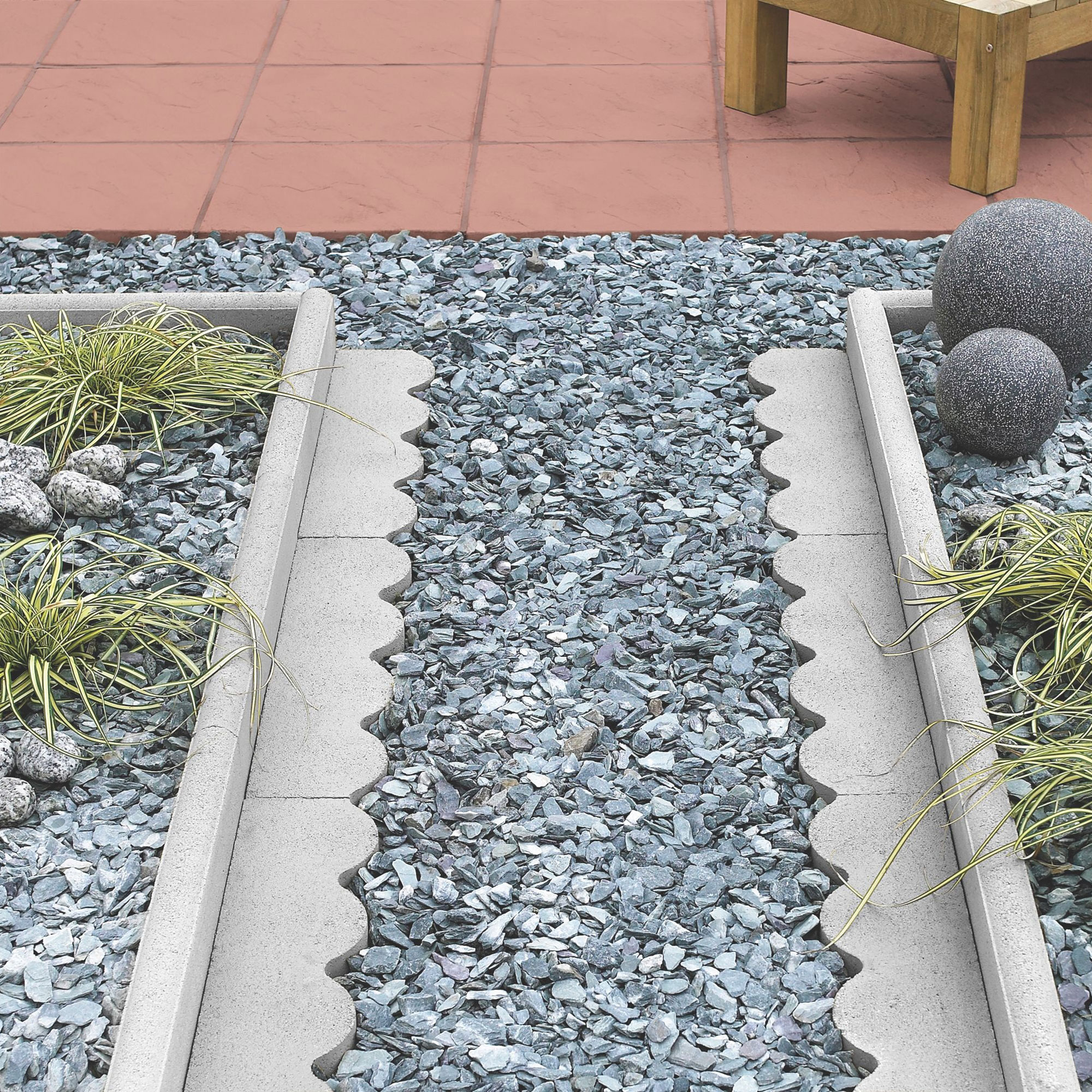 Paving edge in wibbly line alongside path of stones
