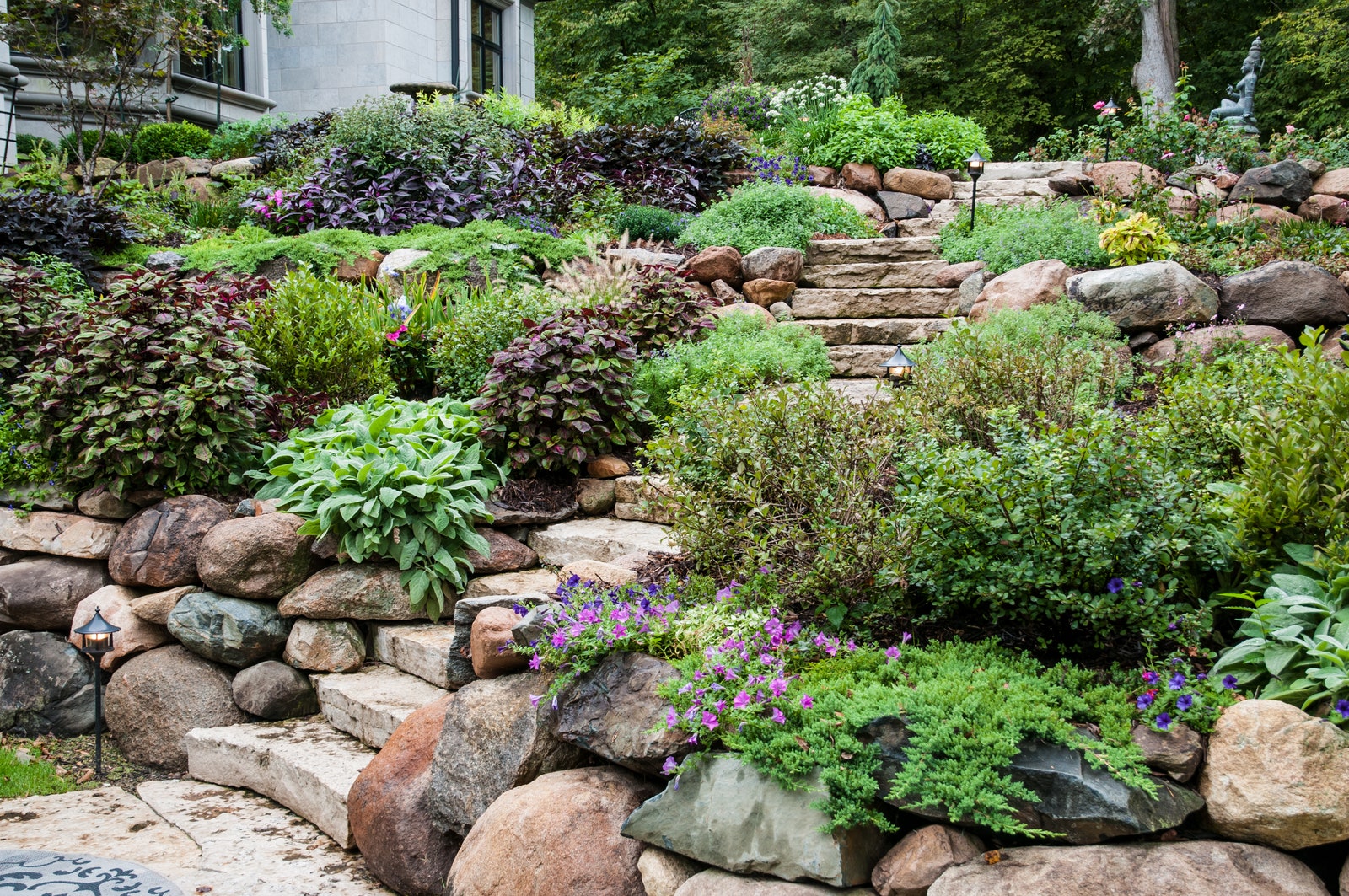 Stone by stone Big boulders give landscaping organic structure.